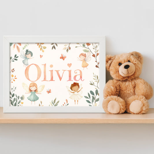 Personalised framed children's name print in a fairy theme next to a teddy bear on a shelf.